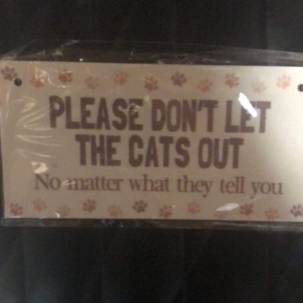 “Don’t let the cats out ....” sign